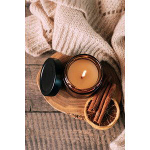 Umělecká fotografie Candle in small amber glass jar with wooden wick on wooden stand on background. Top view, Alexandr Kolesnikov, (26.7 x 40 cm)