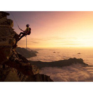 Umělecká fotografie Climber on a rocky wall over clouds, Buena Vista Images, (40 x 30 cm)