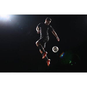 Umělecká fotografie Football player jumping with ball on, Stanislaw Pytel, (40 x 26.7 cm)