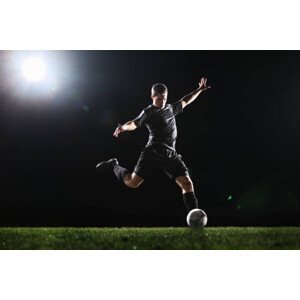 Umělecká fotografie Soccer player kicking ball on grass,, Stanislaw Pytel, (40 x 26.7 cm)