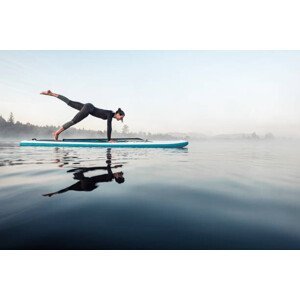 Umělecká fotografie Woman practicing paddle board yoga on, Westend61, (40 x 26.7 cm)