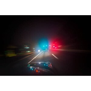 Umělecká fotografie Car driving down road with red and blue lights, Hillary Kladke, (40 x 26.7 cm)