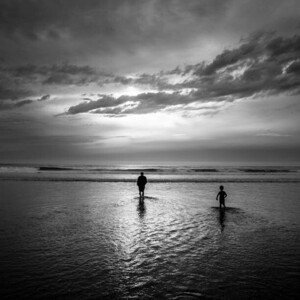 Umělecká fotografie A father and son wade into, Cavan Images, (40 x 40 cm)