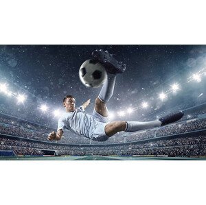 Umělecká fotografie Soccer player kicking ball in stadium, Dmytro Aksonov, (40 x 22.5 cm)