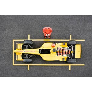 Umělecká fotografie Racecar Driver Standing by Racecar Adjusting, David Madison, (40 x 26.7 cm)